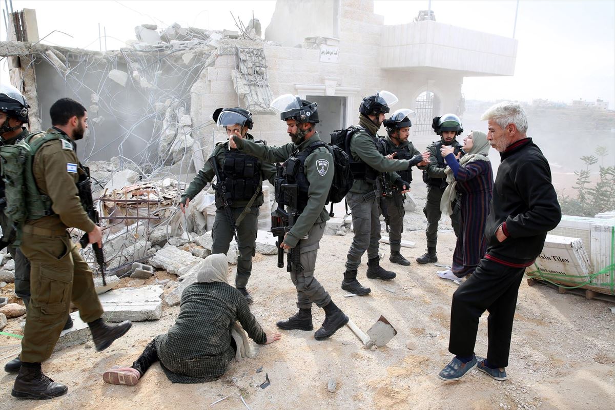 Mujeres palestinas se enfrentan a soldados israelíes para evitar la demolición de su casa.