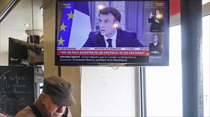 Emmanuel Macron Frantziako presidentea Pariseko taberna bateko telebistan.